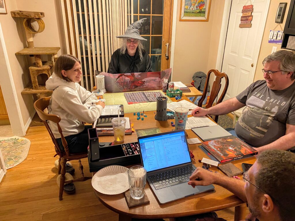 Clockwise from top; DM, chair where cleric sits, Bard, Warlock, Barbarian