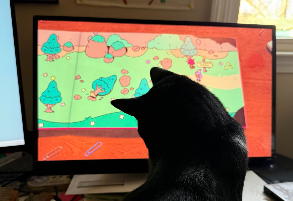 My cat, Midnight, helping me play Plucky Squire